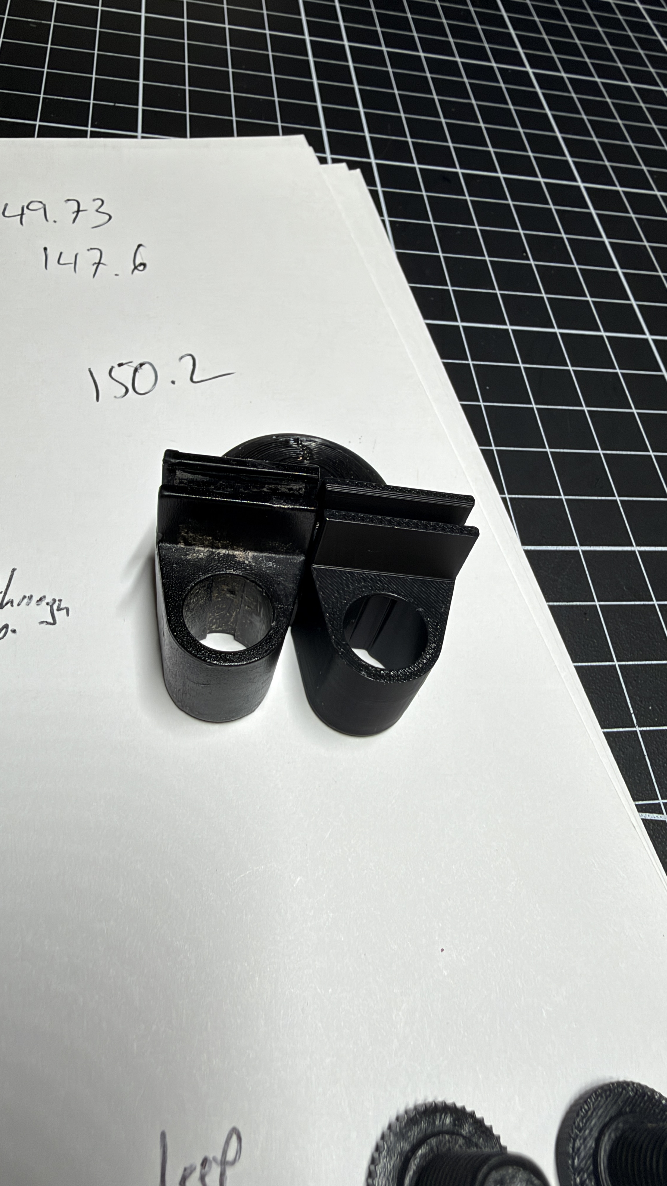 Original and newly printed shower door brackets shown together